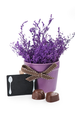 Chocolates and Chalkboard with purple pot flowerの写真素材