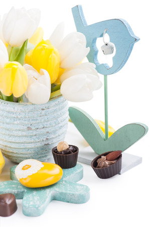 Easter decoration with yellow heart, chocolates and tulip flowersの写真素材