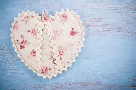 Flat rustic still life, Textile Heart on blue red wooden background in country style for greeting card.の写真素材