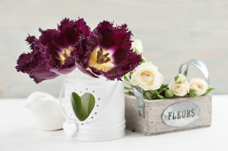 Provence still life. Bouquet of white roses, purple tulips, blue wooden background, wedding decor. Sign on french "Flowers"の写真素材