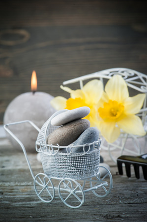 Balancing pebble stones and yellow flowers, ZEN Stone Garden on wooden background, spa tranquil scene conceptの写真素材