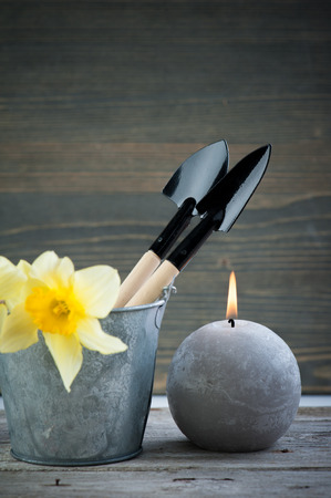 Gardening tools, pots, flowers on vintage wooden table. Spring in the garden backgroundの写真素材