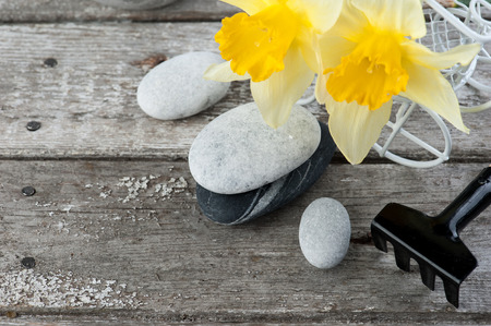 Balancing pebble stones and yellow flowers, ZEN Stone Garden on wooden background, spa tranquil scene conceptの写真素材