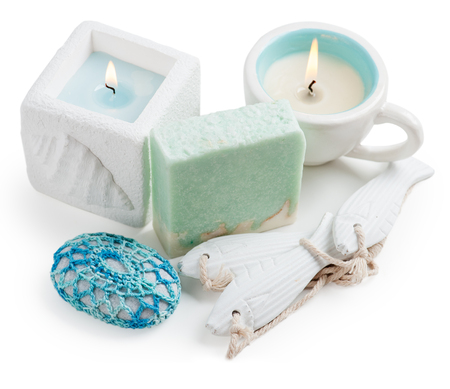 Products for spa, candle, white and turquoise handmade soap and stones on white backgroundの写真素材