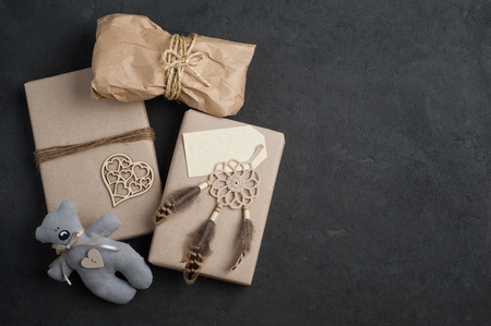 Christmas gifts on concrete background. Craft wrapping and dream catcher decoration. View from aboveの写真素材