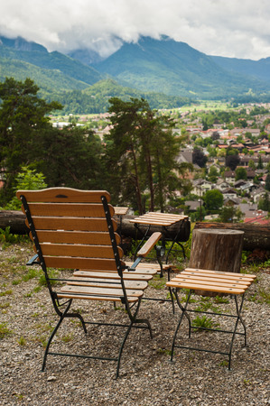 Rustic armchair overlooking peaceful mountain view in Alps. Tourist simple place of restの写真素材