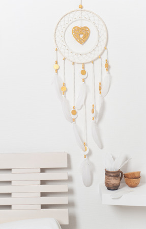 Dream catcher with golden beads and heart in the interior. Wedding bedroomの写真素材