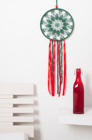 Dream catcher with green red laces in the interior with bottle. Christmas decorationの写真素材