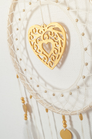 Dream catcher with golden beads and heart in the interior. Wedding closeupの写真素材