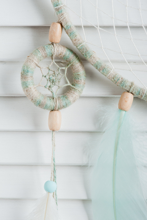 Dream catcher with mint feathers in the interior. Close upの写真素材
