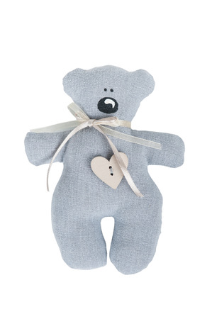 Grey teddy bear with wooden heart button isolated on white backgroundの写真素材