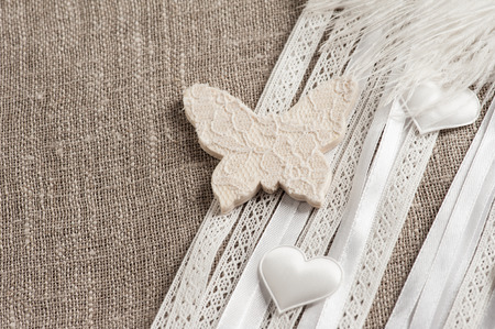 Linen background with wedding decoration. White butterfly. Wedding, xmas rough texture flat layの写真素材