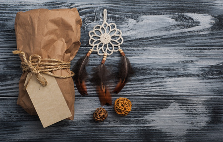 Christmas gifts on wooden background. Craft wrapping and dream catcher decoration. View from aboveの写真素材
