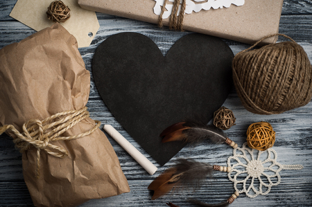 Flat lay background with christmas gift, dream catcher, tag and decoration on wooden background. Craft wrapping. View from aboveの写真素材