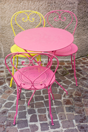 Beautiful pink and yellow chairs in street cafeの写真素材