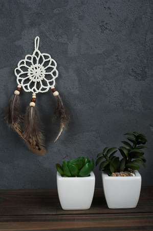 Small dream catcher on concrete background with succulents. Zen decor still lifeの写真素材
