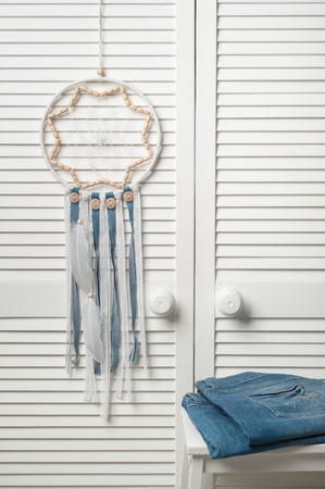 Dream catcher grey blue with white feathers in the interiorの写真素材