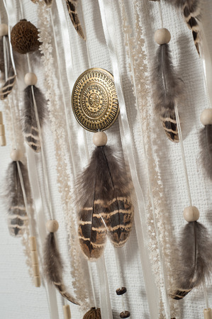 Close-up of brown feathers on background of white, beige lacesの写真素材