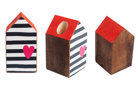 Wooden toy house wit red roof and heart and black stripes isolated on white backgroundの写真素材