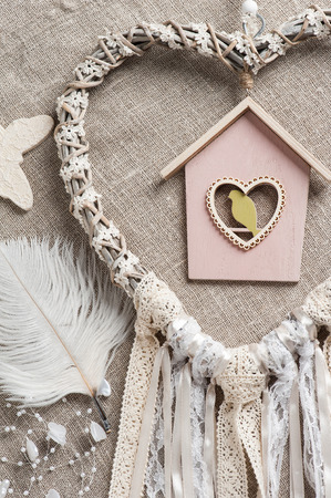 White beige lace heart shaped dream catcher with pearls. Wedding decor backgroundの写真素材
