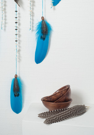 Dream catcher with blue feathers in the interior. Wooden bowlsの写真素材