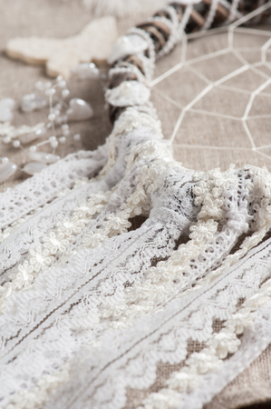 Closeup of white and beige laces. Dream catcher shaped heartの写真素材