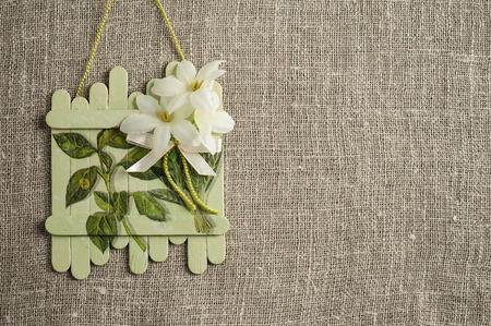 Linen background with wedding decoration. Toy fence with flowers rough texture flat layの写真素材