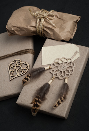 Christmas gifts on concrete background. Craft wrapping and dream catcher decoration. View from aboveの写真素材