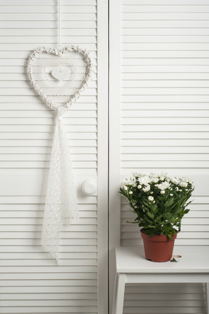 White dream catcher with flowers in bedroom interior. Wedding compositionの写真素材