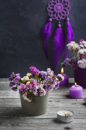 Dry flowers and Purple dream catcher on concrete background. Zen decor still lifeの写真素材