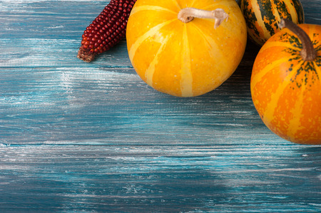 Autumn pumpkins on shabby blue background. Fall harvest flat layの写真素材