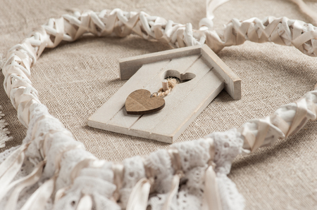 Closeup of white lace heart shaped dream catcher with pearls. Wedding decor backgroundの写真素材