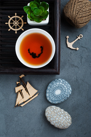 Cup of black tea and crocheted pebbles closeup on concrete background. Zen and mindfulness conceptの写真素材