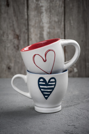 Valentine's day set of cups with hearts over concrete backgroundの写真素材