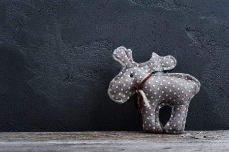 Christmas toy deer on concrete background. Space for greeting text.の写真素材