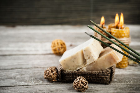 Rustic setting with natural olive soap and honey candles. Copy-space for textの写真素材