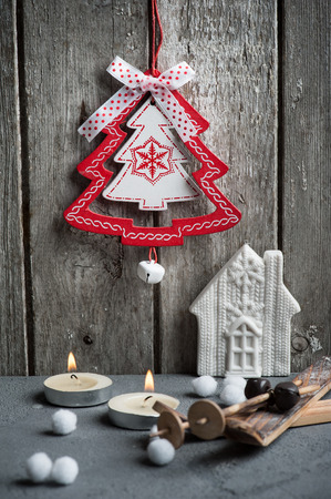 Christmas decoration hanging over wooden background. Xmas composition with wooden ski and lit candlesの写真素材