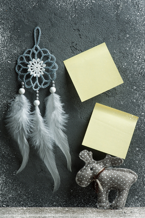 Yelow empty sticky note on concrete wall with christmas decorations. Space for greeting text.の写真素材