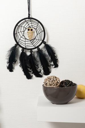 Black dream catcher with metal owls and feathers. Hallowen decor still lifeの写真素材