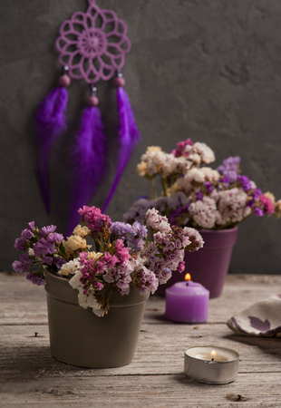 Dry flowers and Purple dream catcher on concrete background. Zen decor still lifeの写真素材
