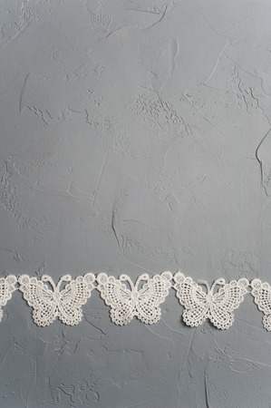 Colorful textile erflies on concrete grey background. Flat lay, view from above, copyspace for textの写真素材