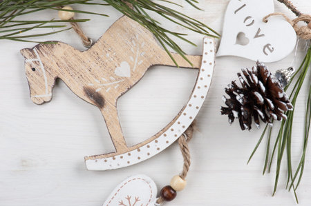 Christmas wooden vintage toys, rocking horse, pine cone. Modern lifestyle composition in scandinavian styleの写真素材