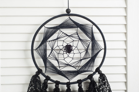 Black dream catcher with crocheted doilies in the interiorの写真素材