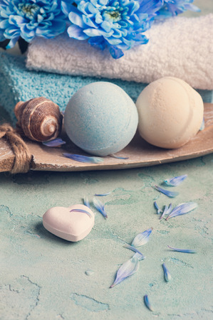 SPA treatment. Blue flowers and bath bombs on concrete background. Toned vintageの写真素材