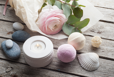 SPA still life, ranunculus, pink vanila bath bombs on old wooden backgroundの写真素材