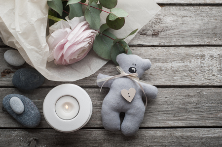SPA still life, ranunculus, pebbles and lit candle on old wooden backgroundの写真素材