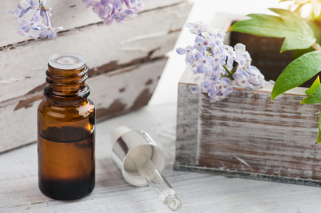 Bottle of essential oil with fresh lilac flowers. Spa beauty treatmentの写真素材