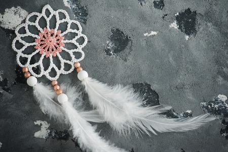 White dream catcher closeup on concrete tableの写真素材