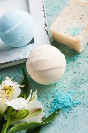 Bath bombs on blue concrete background, organic soap and saltの写真素材