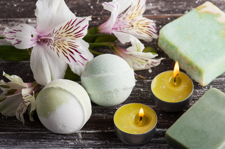 SPA composition with bath bombs, soap, lilly. Wooden background の写真素材